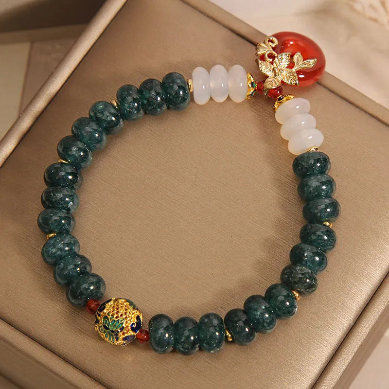 Blue jade and red agate bead bracelet with a crystal peace buckle closure.