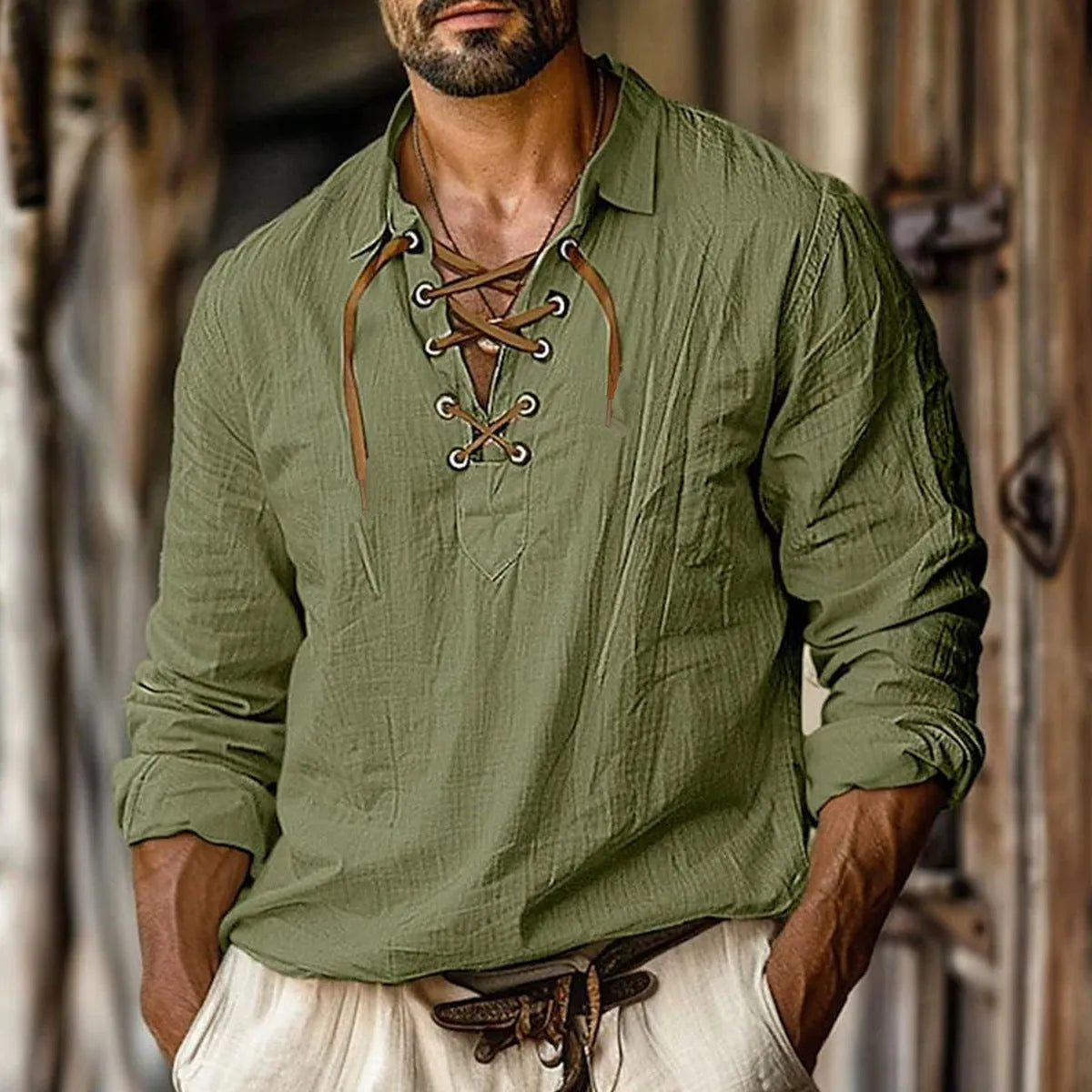 Men's loose blue linen blend shirt with lapel and lace details on a hanger