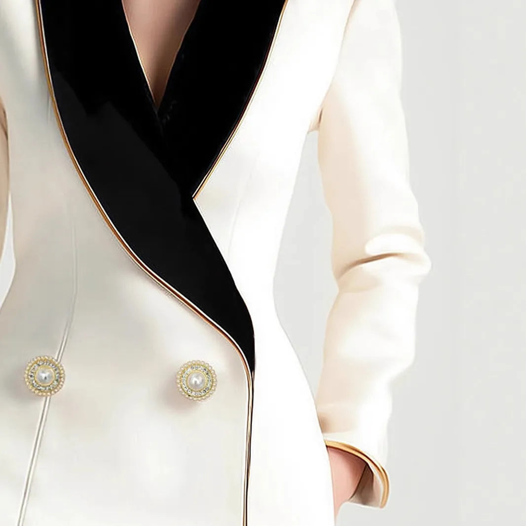 Women's beige long sleeve coat with irregular hemline and golden pearl buttons on a hanger.