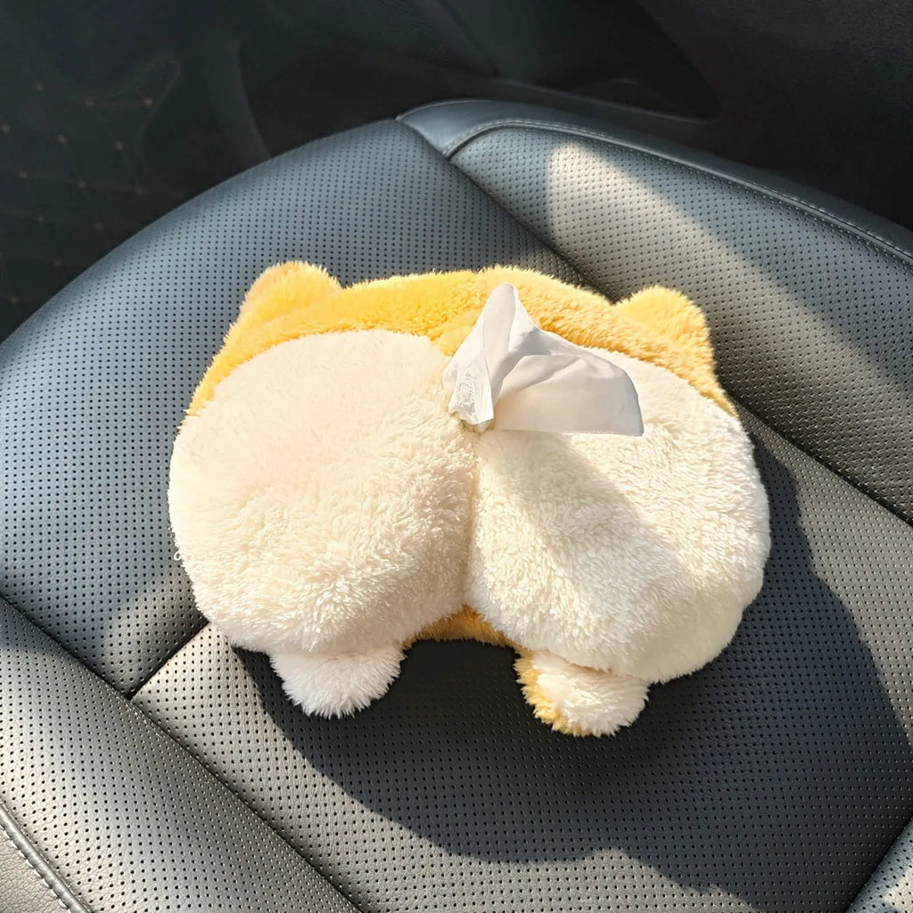 Yellow corgi butt shaped car tissue box cover hanging from a sun visor
