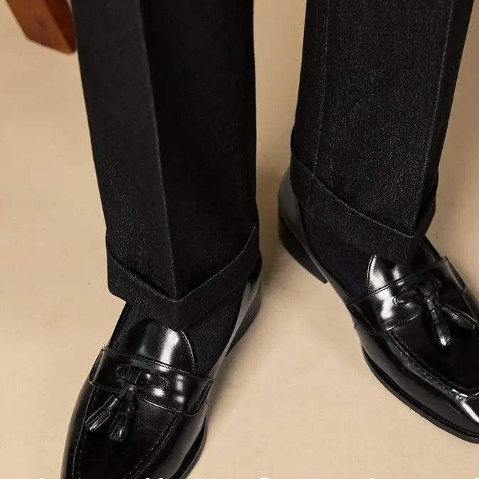 Men's genuine leather tassel loafers in black and brown colours showing polished upper and rubber sole