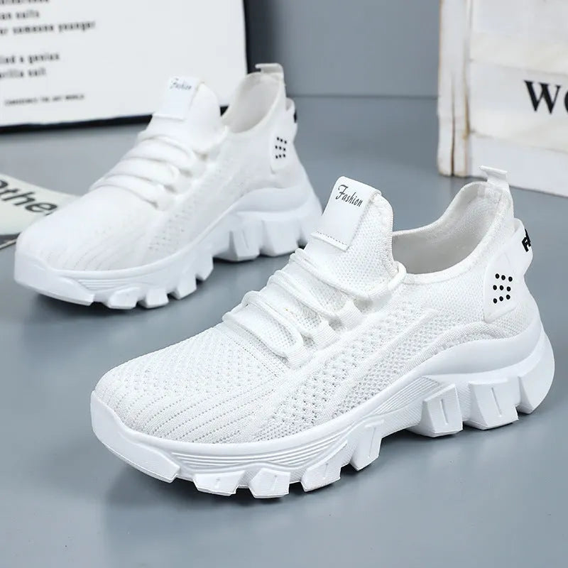 Women's white Flyknit sneakers with thick PVC sole and lace-up front