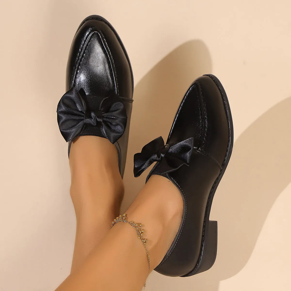 Women's British-style flat shoes with bow detail, pointed toe, and rubber sole