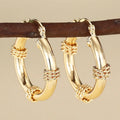 Geometric copper ear clips for women in a golden colour with clean line detailing on a white background.