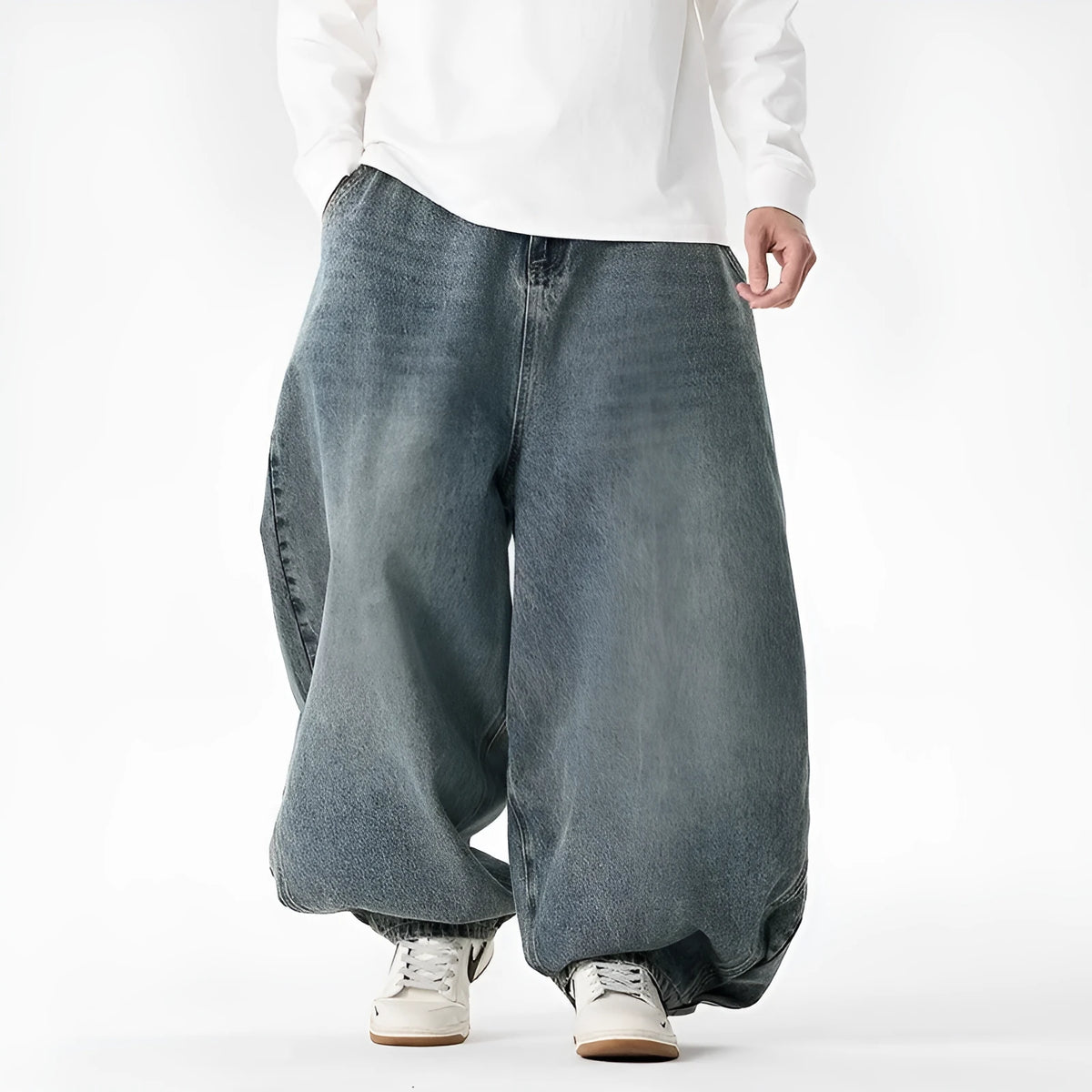 Men's loose fit light blue denim jeans with a straight leg and low waist, laid flat.