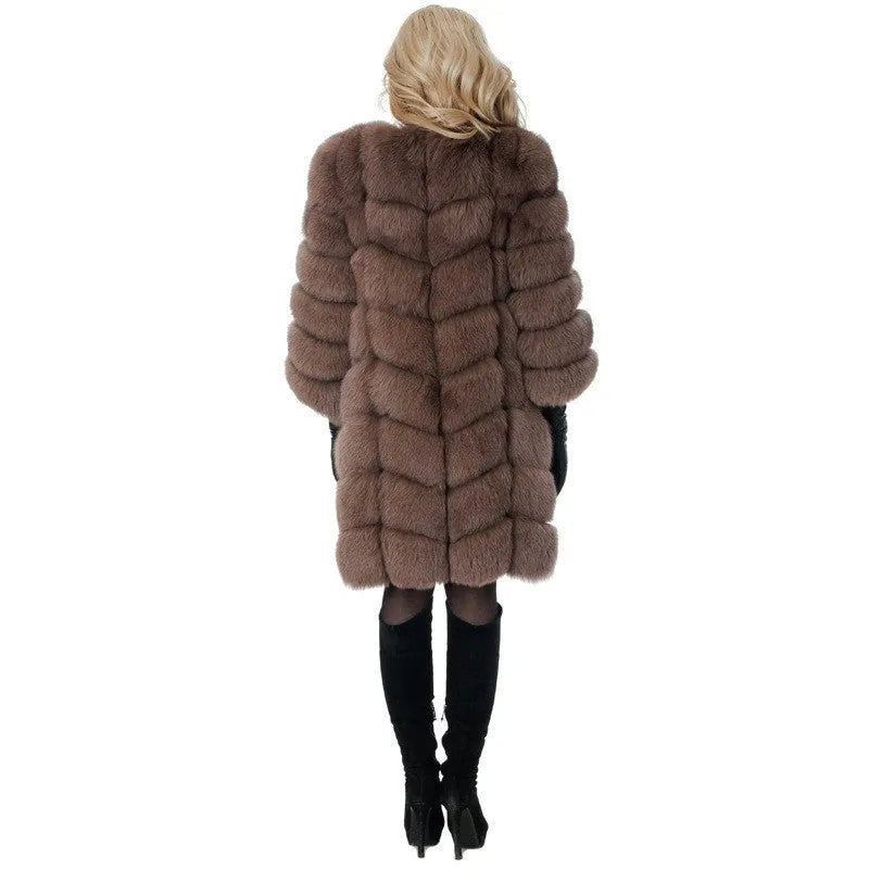 Women's long artificial fur coat in a choice of five colours, shown in a commute style setting.