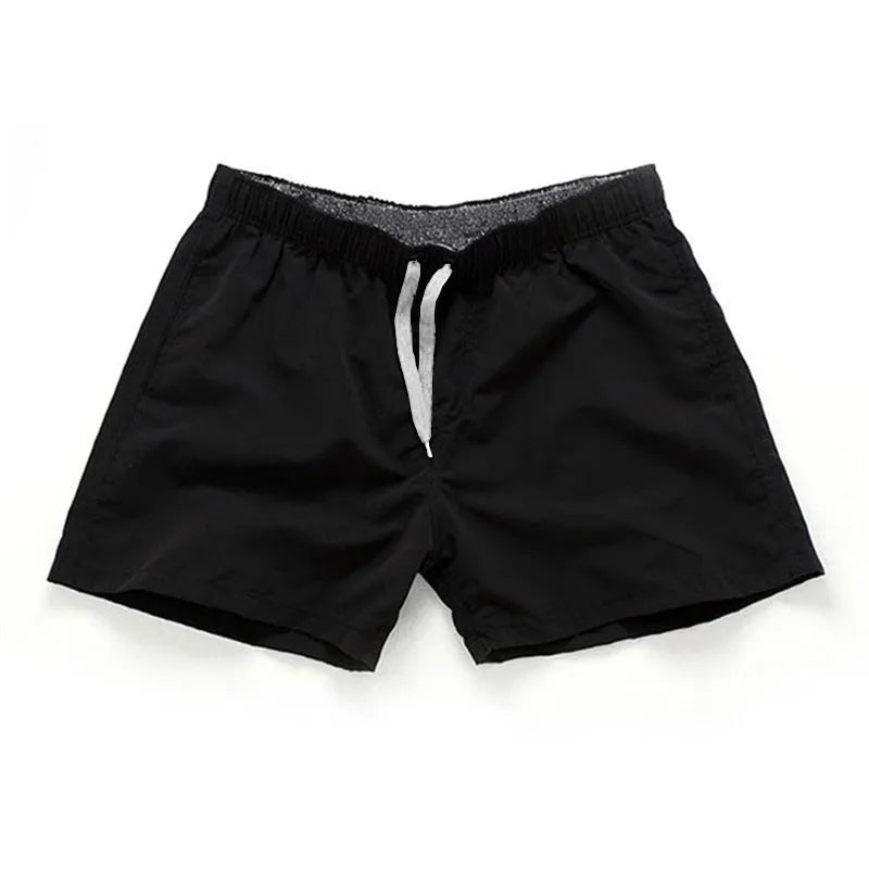 Men's polyester beach shorts in black with straight leg opening and grinded fabric texture available in sizes S to 4XL