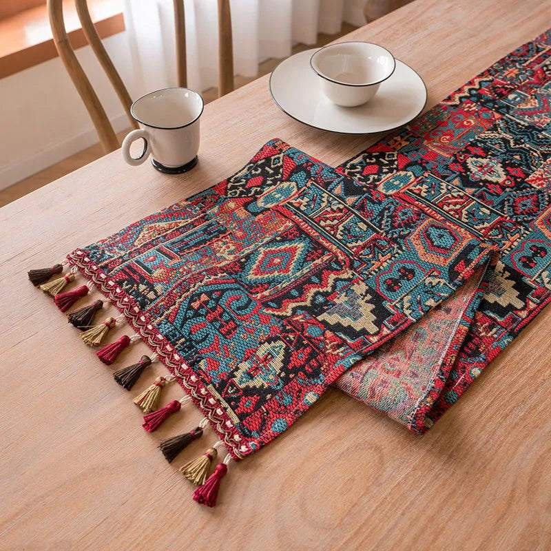 Dark blue striped floral jacquard table runner laid flat on a wooden dining table.