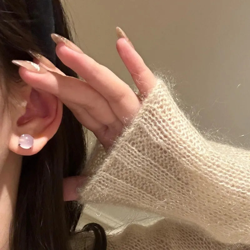 Round chalcedony stud earrings with four claw copper settings in green, white, or pink.