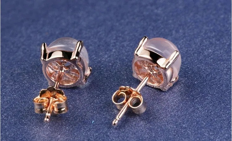 Rose gold drop shape stud earrings with crystal inlay detail on synthetic ross quartz