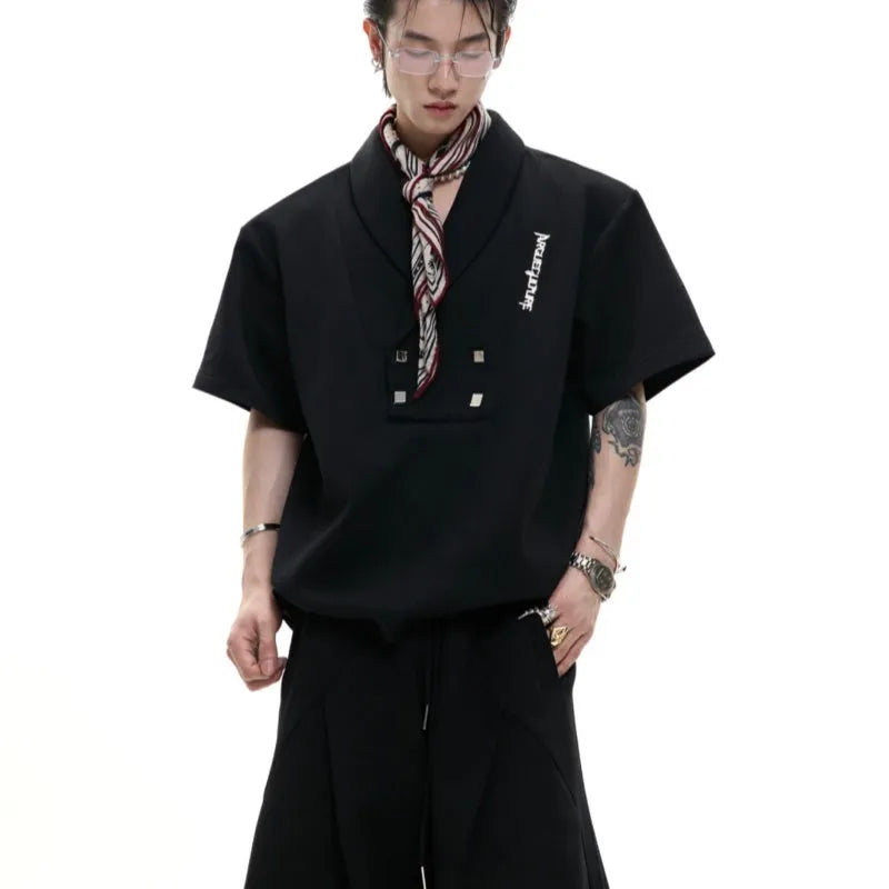 Men's dark grey cotton sports suit with V-neck jacket featuring padded shoulders and metal details, worn with matching shorts