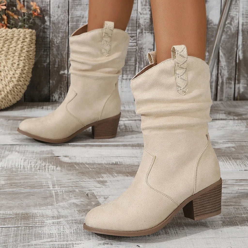 Women's mid calf suede boots in lotus root colour with leather stitching and a mid heel.