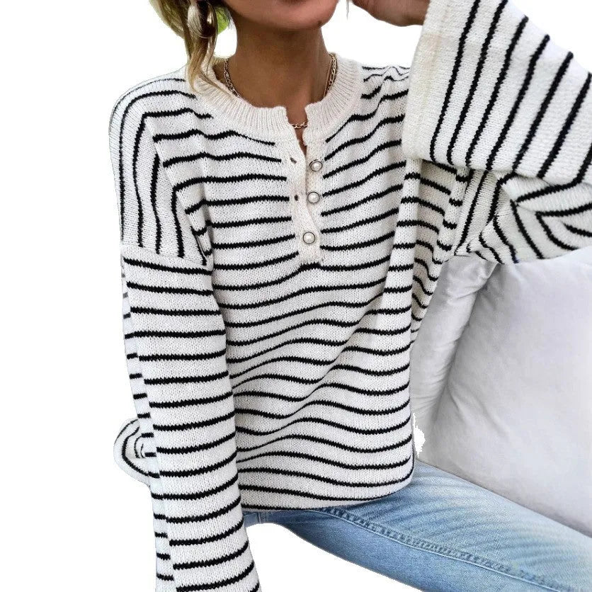 Black striped women's knitted top with drop shoulder sleeves on hanger