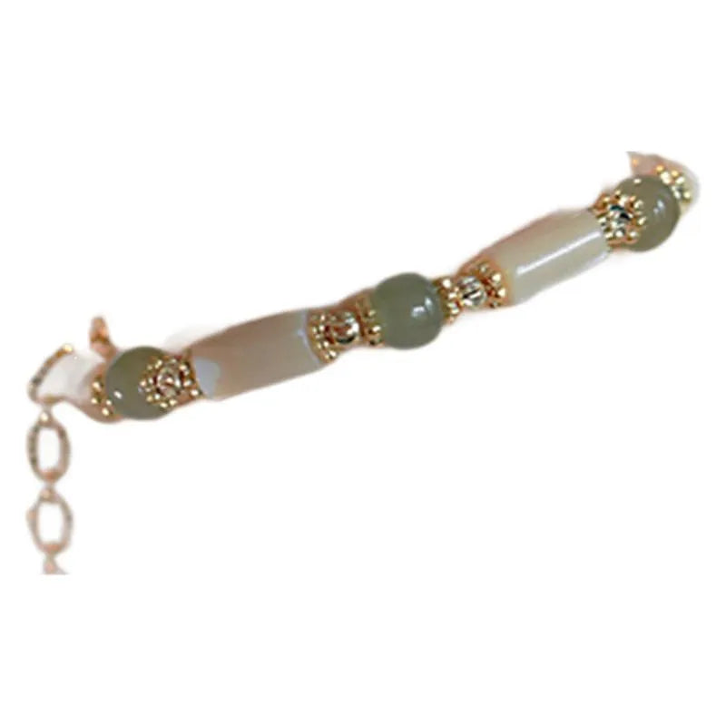 A women's adjustable bracelet made of round white Hetian jade beads in a simple geometric design.