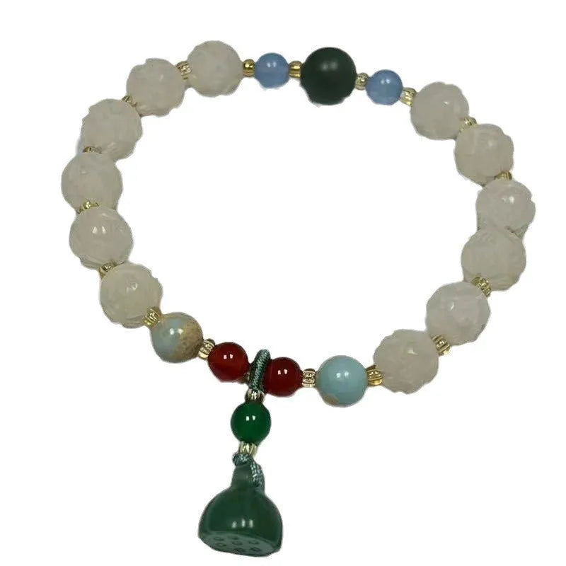 Carved bodhi root bracelet with pumpkin lotus beads and white jade lotus detailing in multiple bead sizes