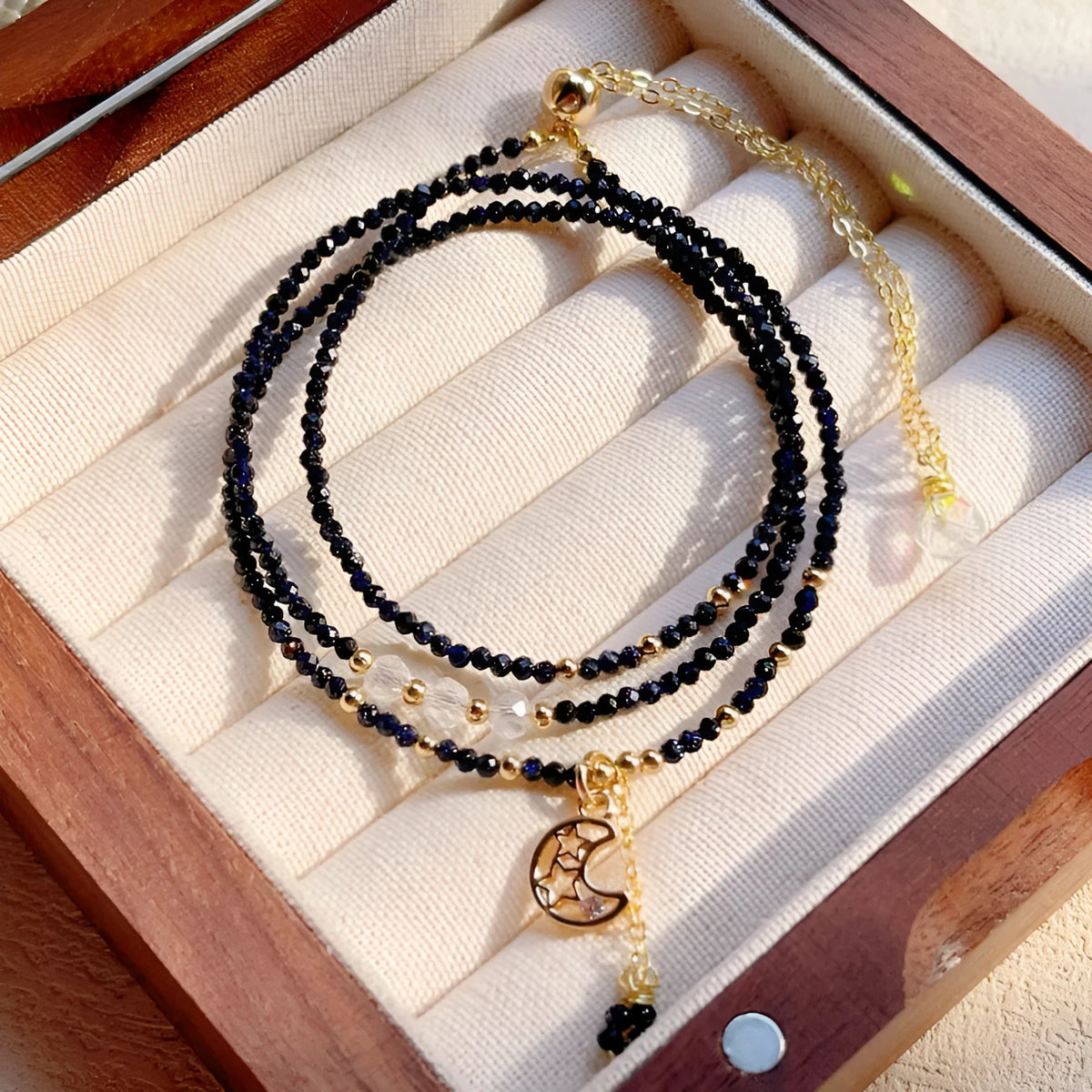 Blue and gold multi-layer women's bracelet with cut sand stone on a three-ring design.