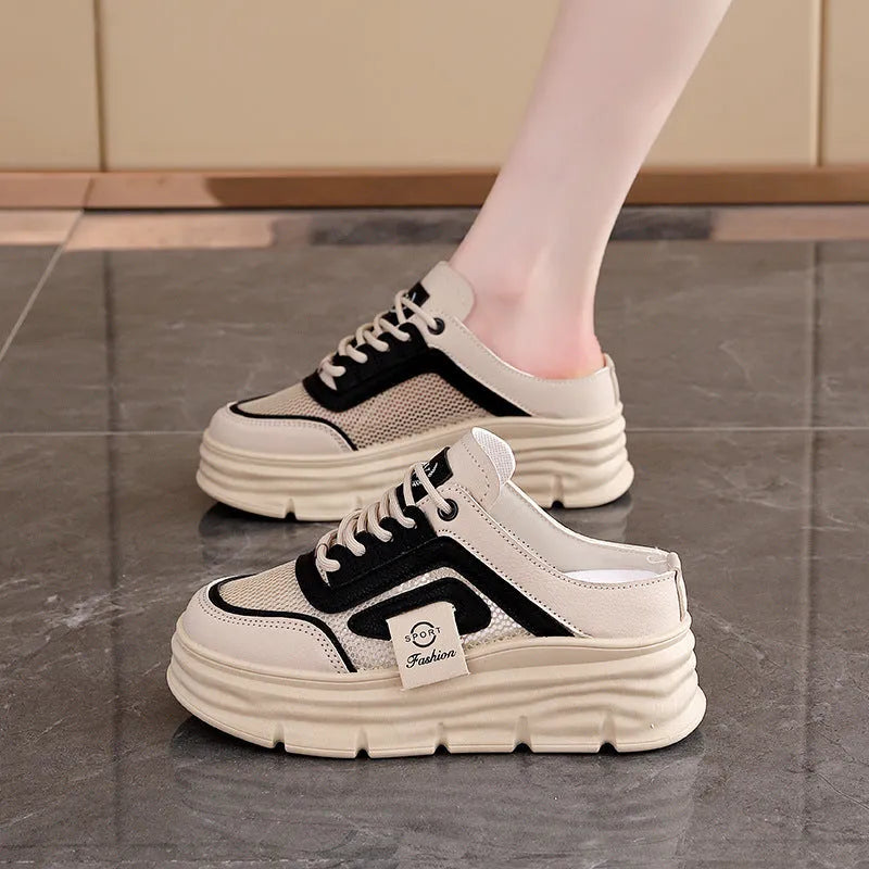 Women's black mesh half slippers with round toe and rubber sole, showing height increasing feature