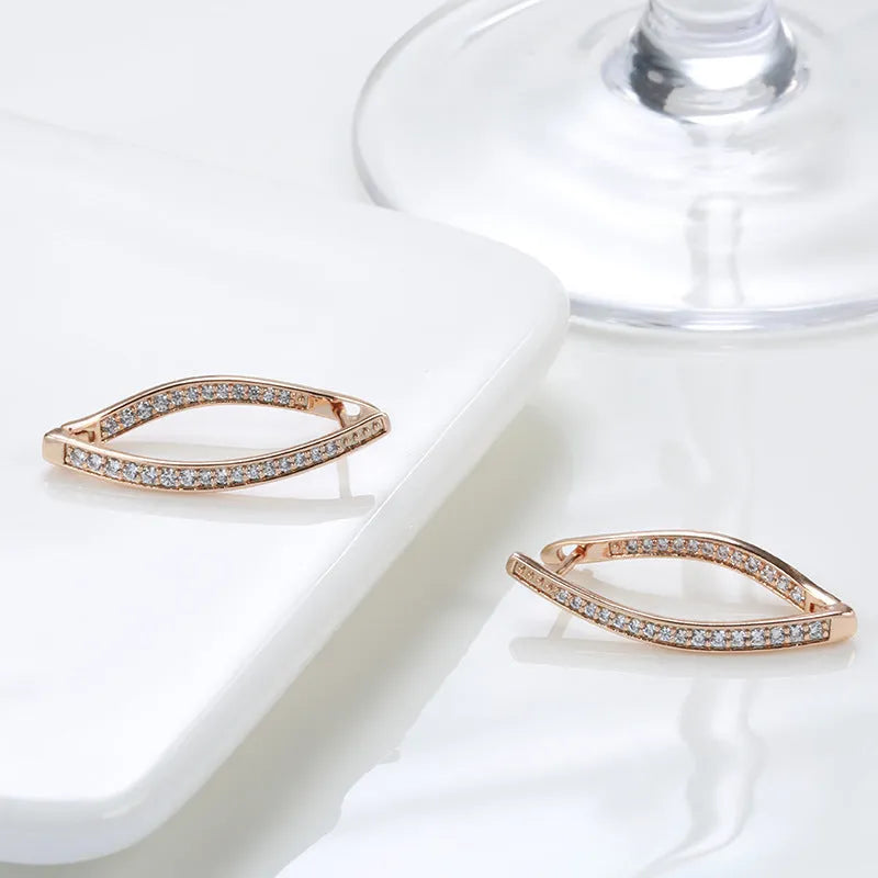 A pair of geometric-shaped copper earrings with zircon detail in H0493 colour, shown from the front.