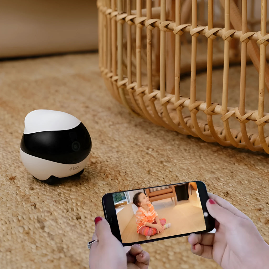 White smart home mobile surveillance robot camera on table with automatic docking station