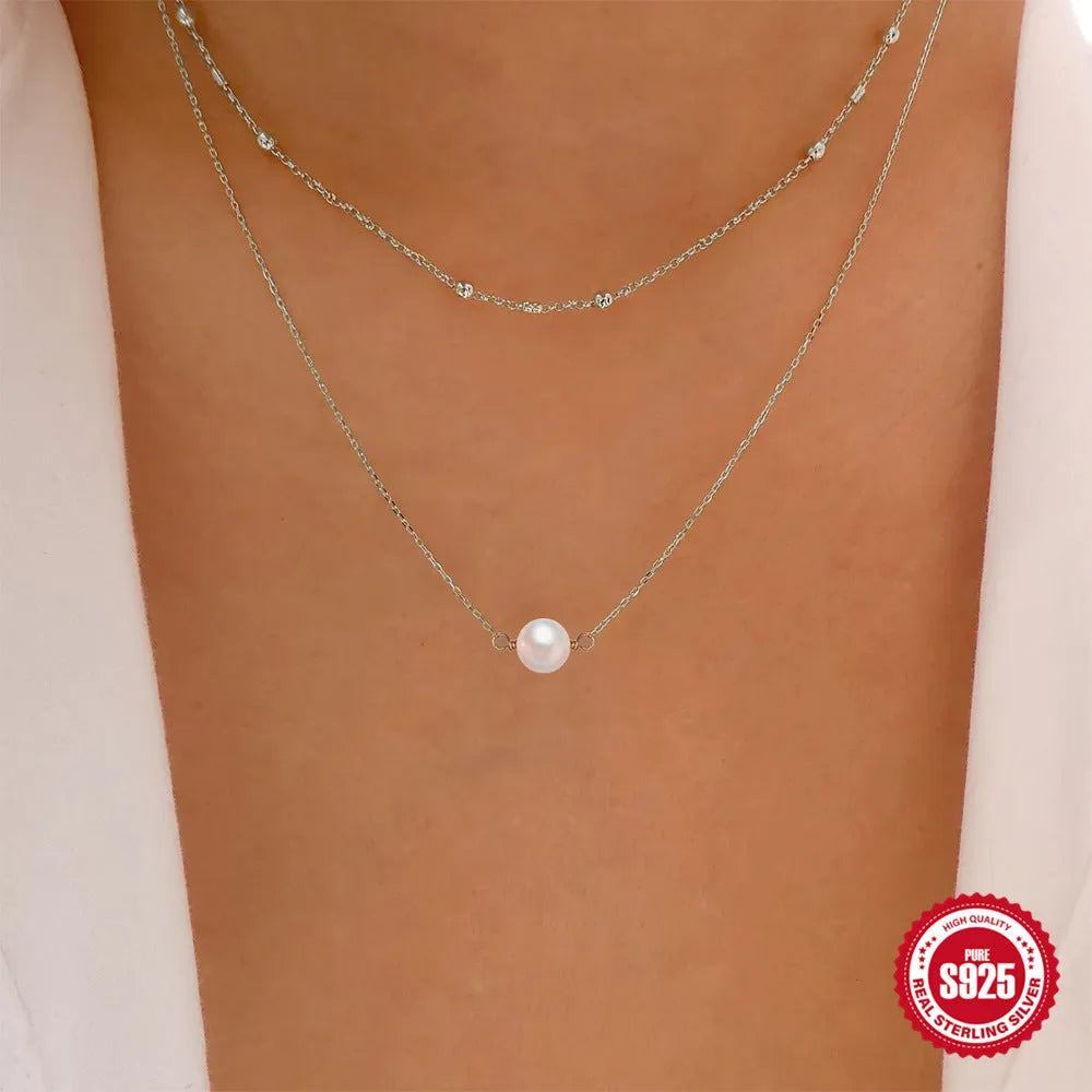 Sterling silver double layer necklace with twin pearl pendants in geometric settings