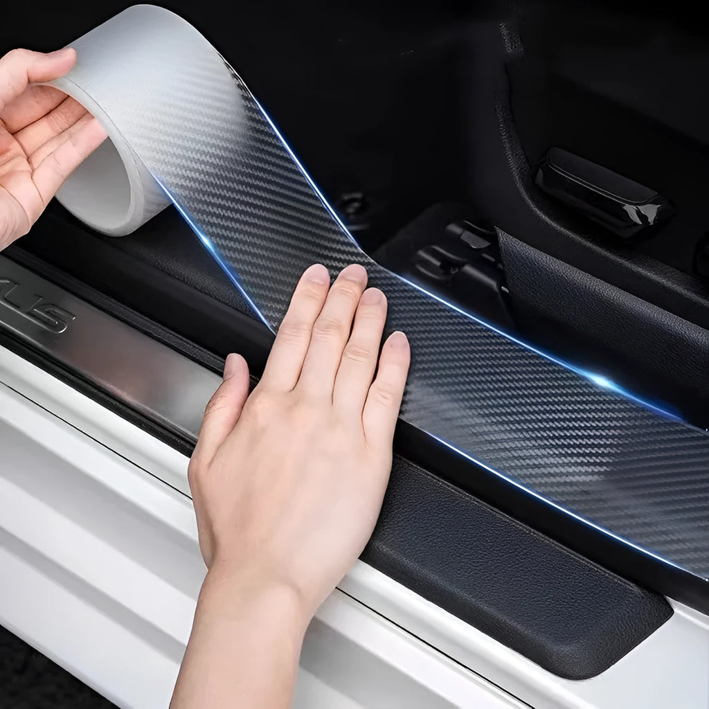 Carbon fibre textured car anti-collision protection strip on a roll with scraper tool.