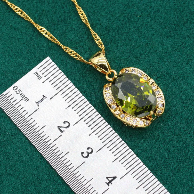 Olive green zircon jewellery set with snake bones chain necklace, matching earrings, and ring on a copper base.