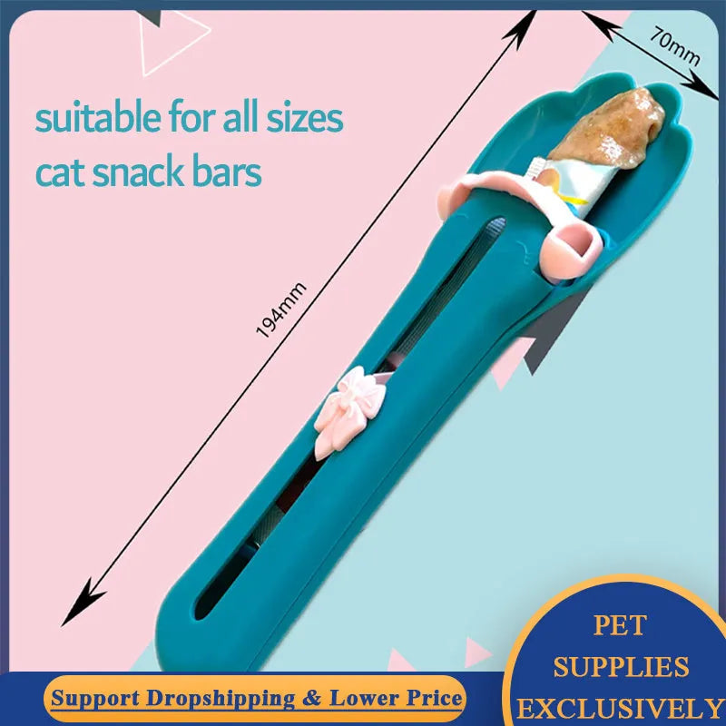 Green and pink pet food scoop squeezer feeder for dispensing snacks and liquids for cats and dogs.
