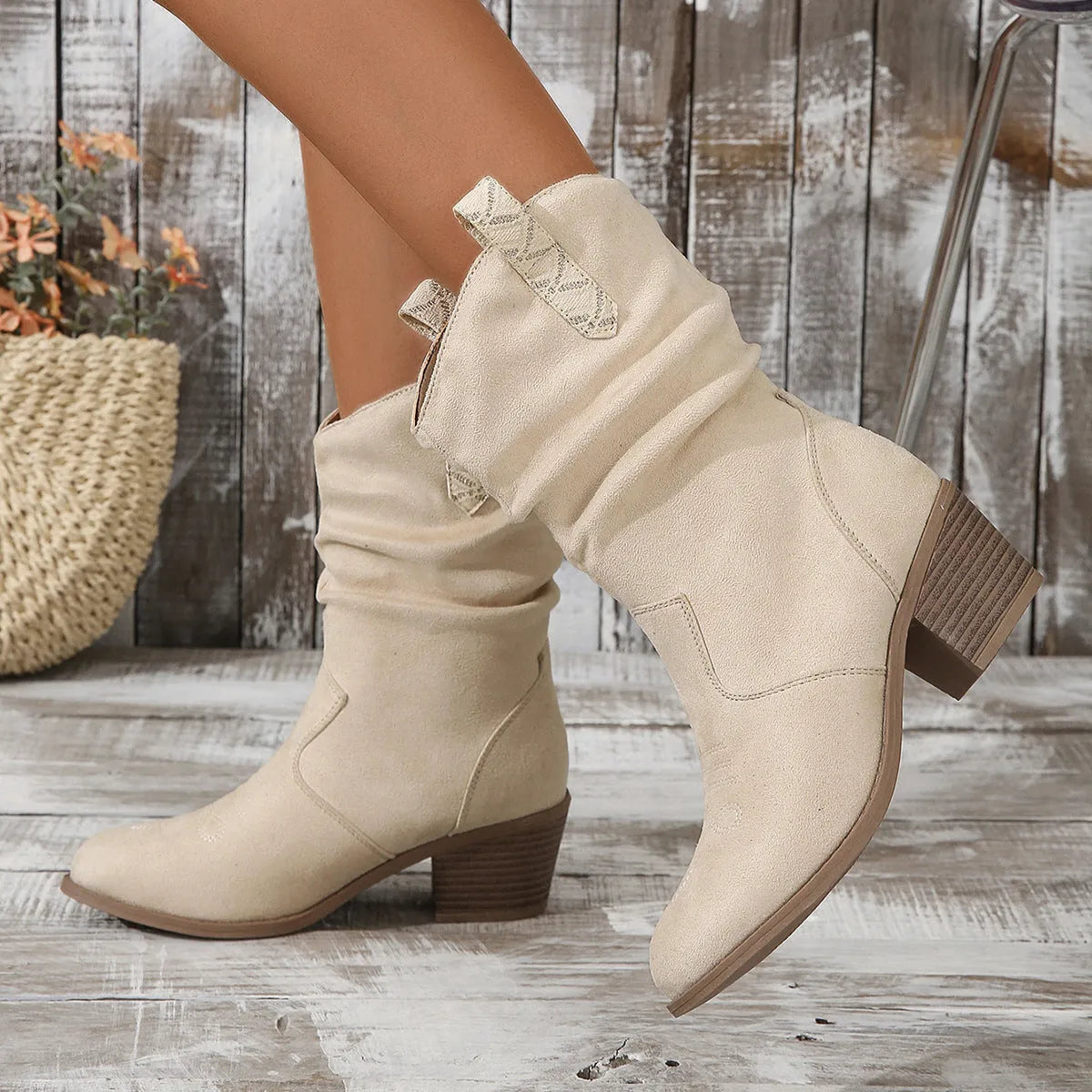 Women's mid calf suede boots in lotus root colour with leather stitching and a mid heel.