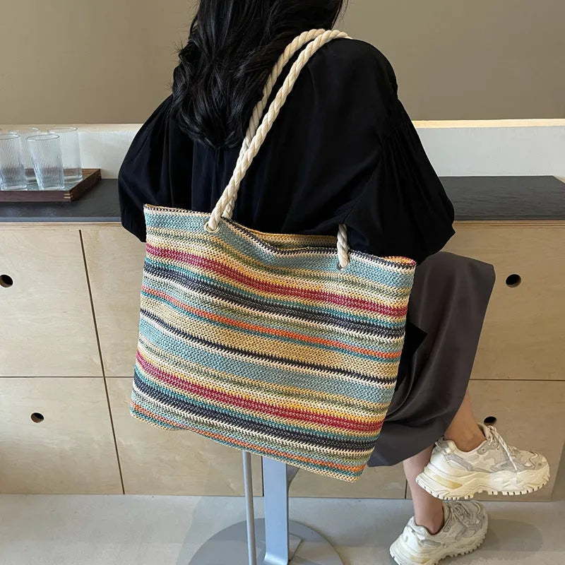 Blue straw woven large capacity single shoulder bag with nylon exterior and polyester lining.