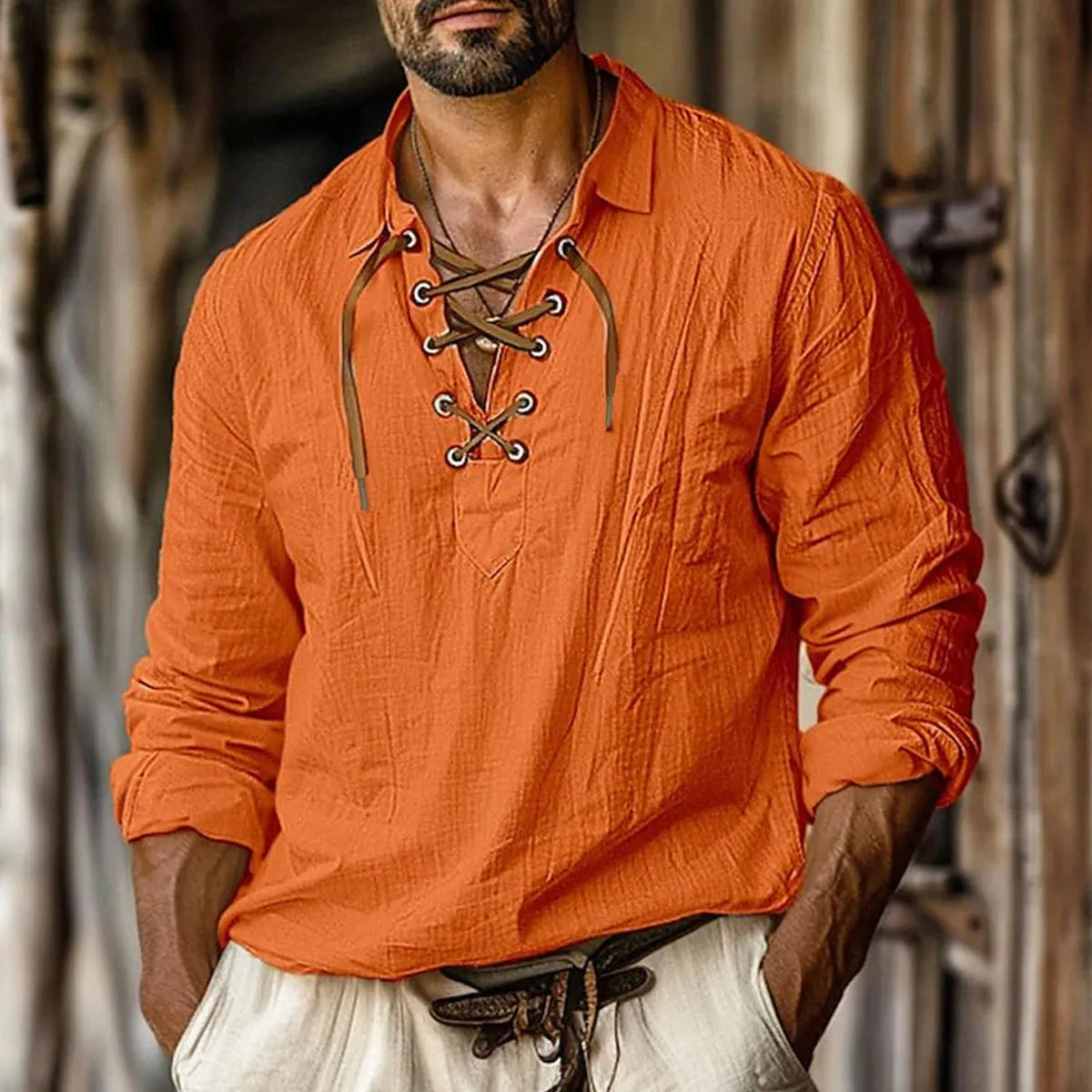Men's loose blue linen blend shirt with lapel and lace details on a hanger