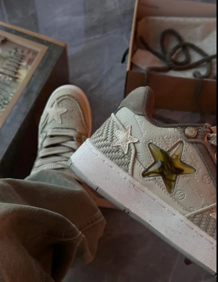 Green low-top casual shoes with star pattern stitching and white rubber sole.