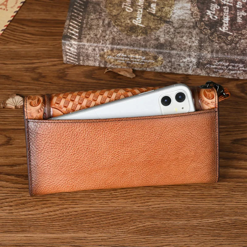 Women's brown embossed floral genuine leather tri-fold wallet showing interior compartments