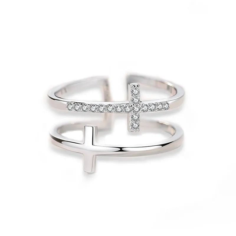 Women's adjustable double cross copper ring with zircon stones in sterling silver inlay, shown in a gold electroplated finish.