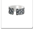 Silver ring with multiple five-pointed star geometric pattern on an adjustable band.