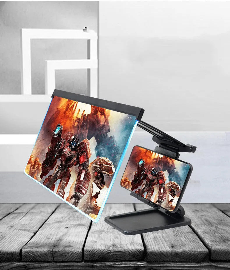 Black folding mobile phone screen amplifier with detachable holder, shown magnifying a smartphone display.
