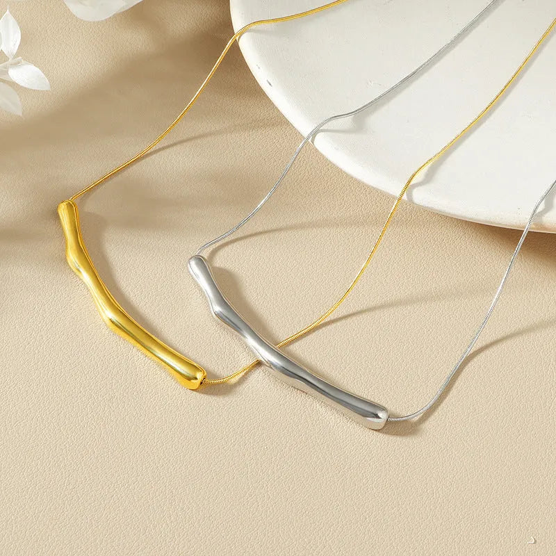 Women's titanium steel pleated necklace in gold tone with irregular textured finish.
