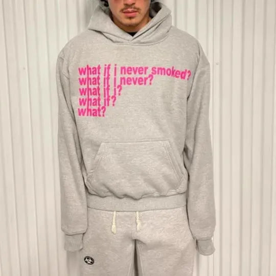 Black hooded sweater with white letter print on front, model wearing size M.
