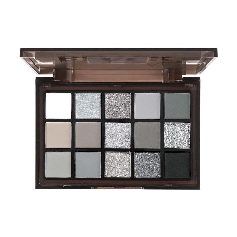 15-colour eye shadow palette showing matte and shimmer finishes in grey, black, brown and blue tones