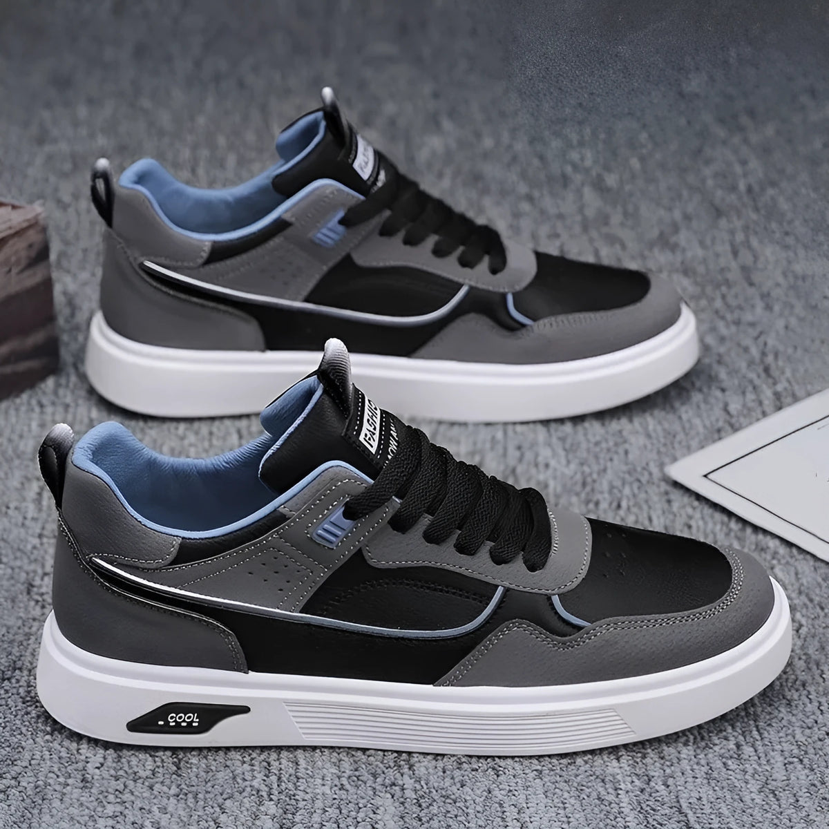 Men's low-top canvas board shoes in black with leather stitching and mesh lining.