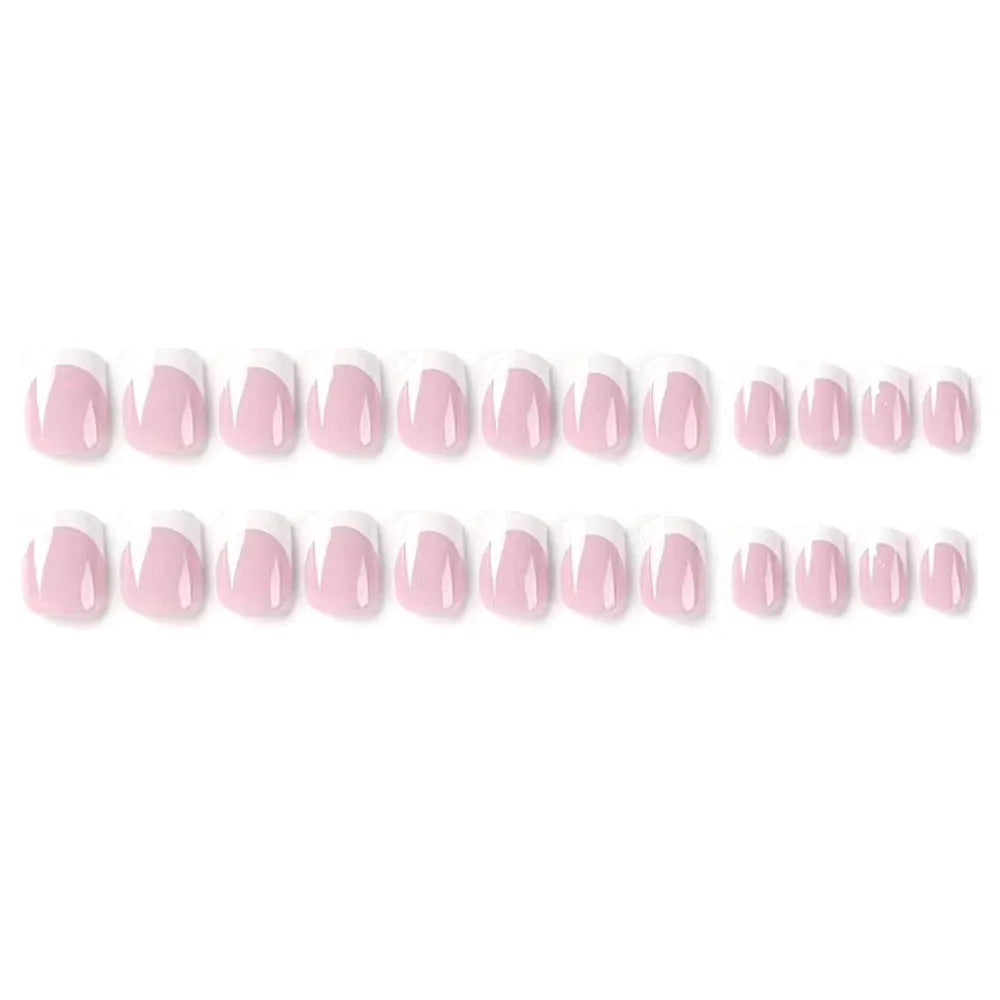 24 white plastic fake nails with a black and grey plaid pattern, arranged on a table.
