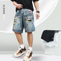 Blue men's denim shorts with ripped knees and graffiti-style print, featuring a straight leg and zipper fly.
