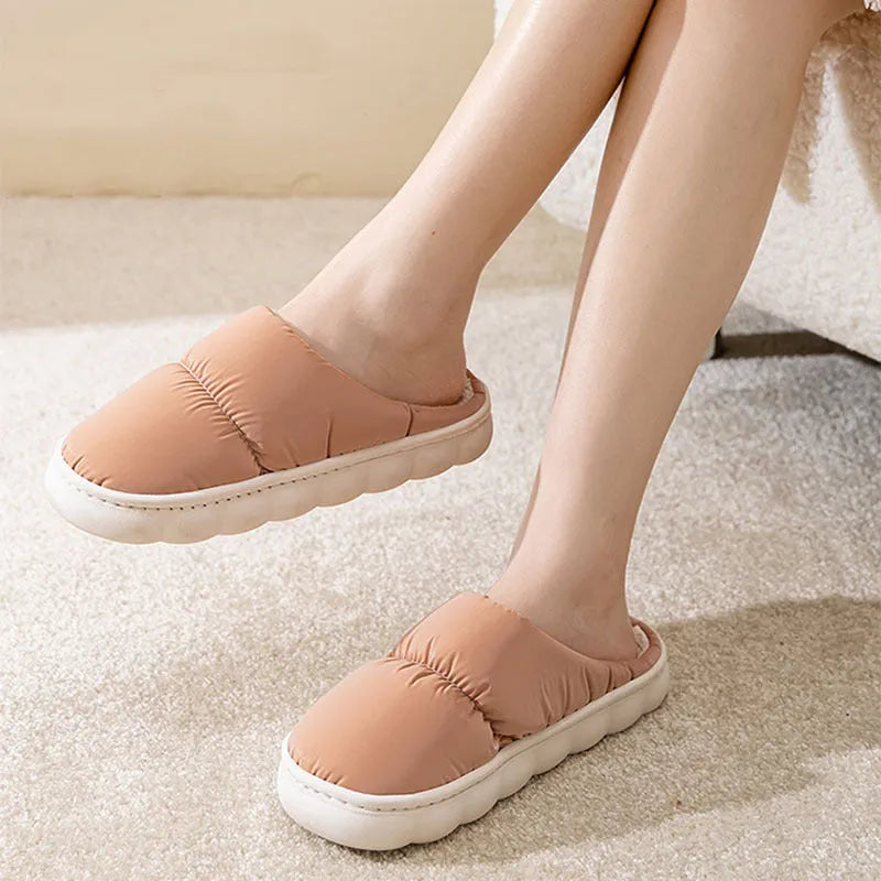 Blue down cotton slippers with a thick rubber sole and plush lining for indoor winter wear.