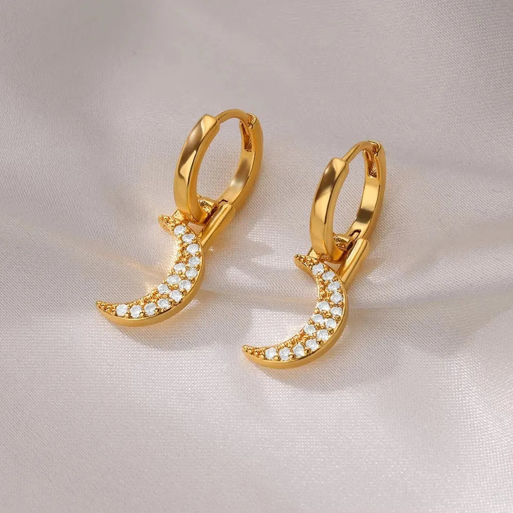 A pair of women's geometric butterfly-shaped earrings made from copper with heart and star details.