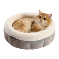 Round donut dog and cat bed in faux rabbit fur with anti-slip bottom and raised sides, available in five sizes