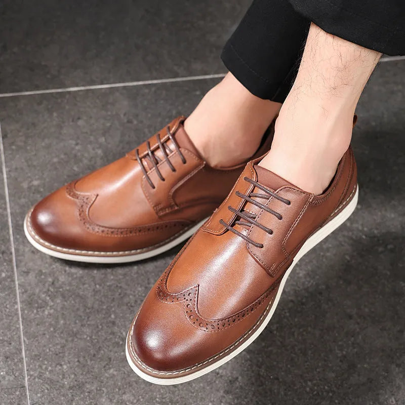 Men's black slip-on business casual shoes with round toe and carved detail on a PU upper.