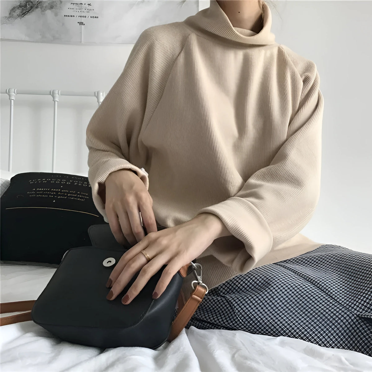 Women's solid colour long sleeve top with a half-high collar shown in a loose fit.