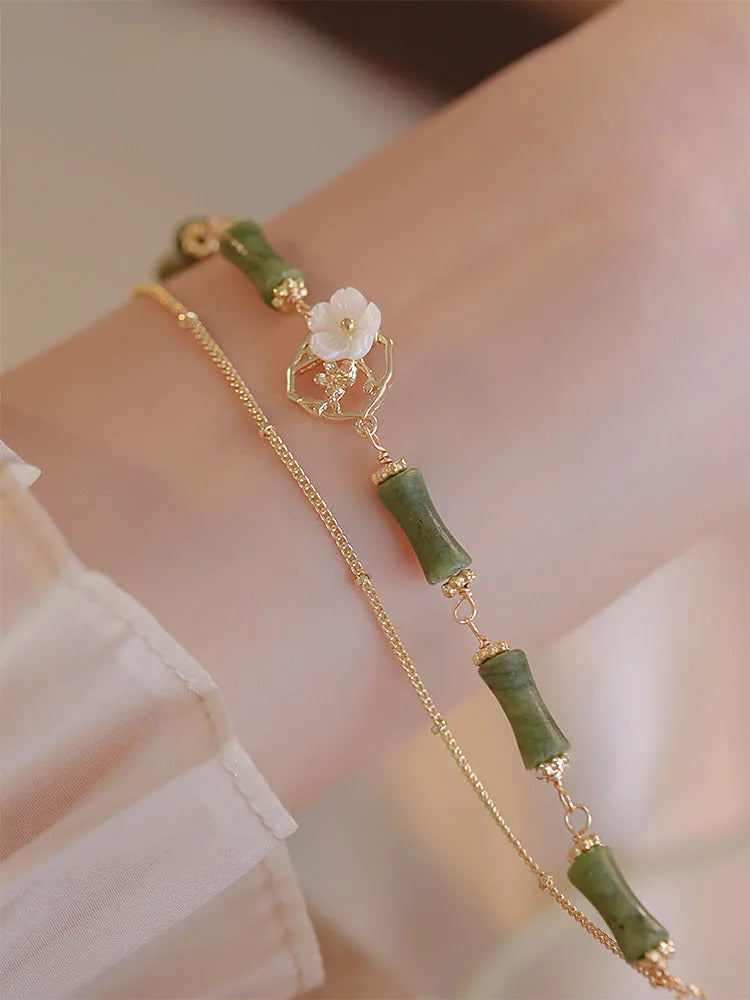 Natural green olivine stone bracelet with double layer Twin Bells of Ireland and Olive Branch design on an adjustable band.