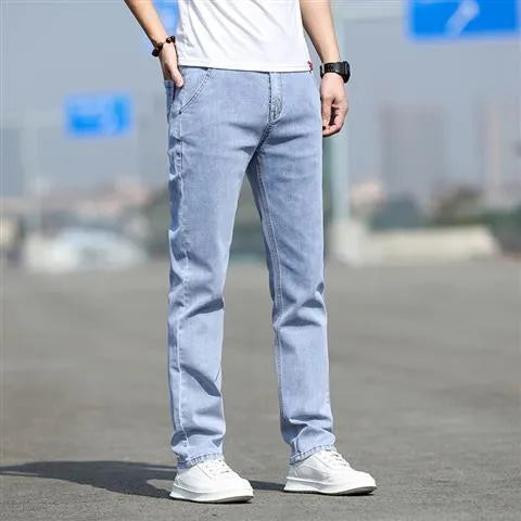 Men's smoky gray straight leg jeans with low waist design and zipper fly closure