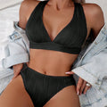 Women's halter strap bikini in black or pink with matching top and shorts