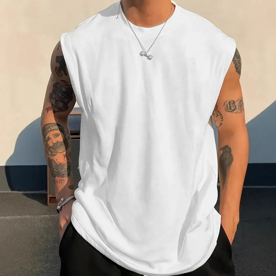 Men's loose fit solid colour cotton tank top on a hanger, shown in apricot colour.